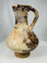 Islamic ceramic pouring vessel from Kashan with pear shaped body and pedestal foot