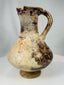 Islamic ceramic pouring vessel from Kashan with pear shaped body and pedestal foot