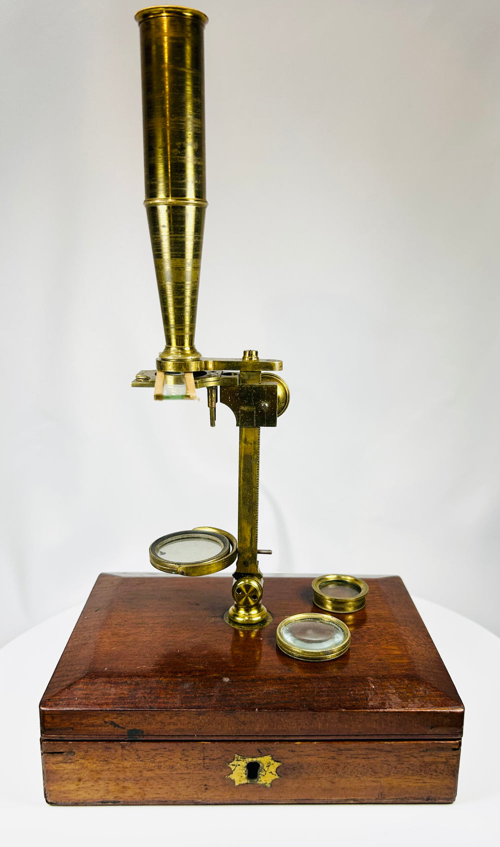 Victorian era brass microscope with bullseye condenser and mirror