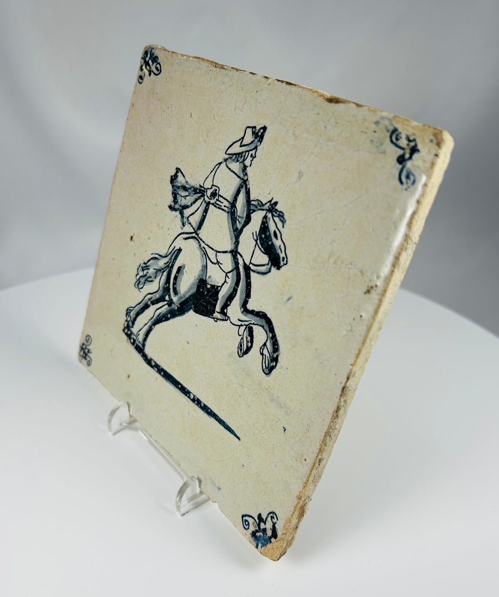 blue and white Delft ceramic tile with rider and horse scene