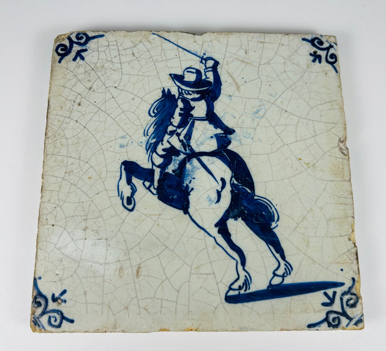 hand painted Dutch Delft tile with swordsman on horseback