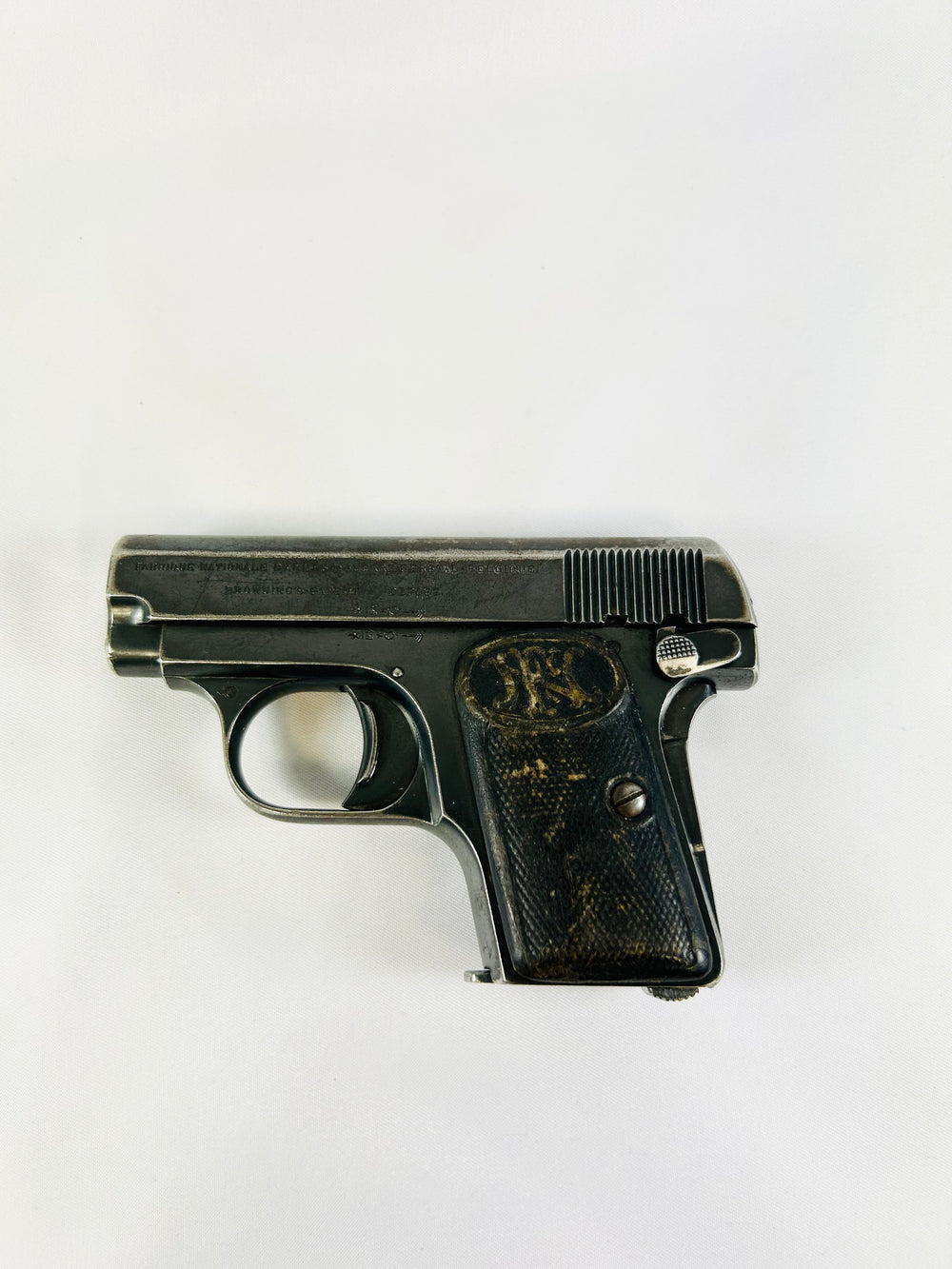 Deactivated Browning FN 1906 third-variant “Triple Safety” pocket pistol with grip, manual, and magazine safeties