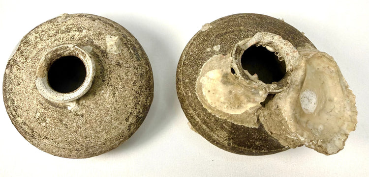 Two Ming Dynasty Chinese stoneware vessels featuring discoid bodies, short necks, flared rims, and partial brown glaze with centuries-old barnacle deposits.