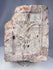 Antique European ecclesiastical stone relief showing a crucifixion scene with carved buildings and tree motif