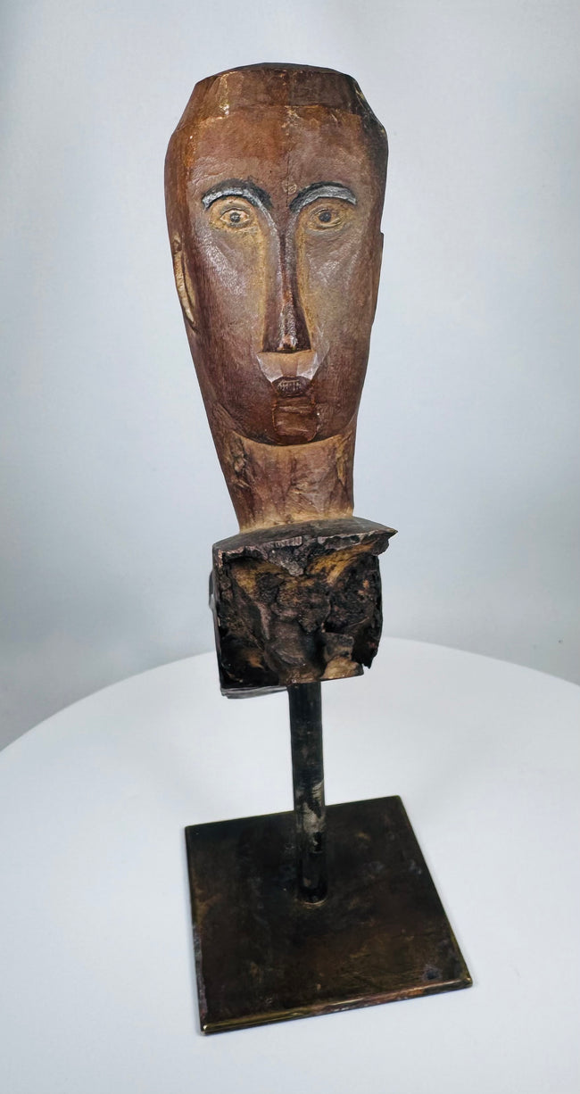Hand-carved tribal architectural figure fragment from Southeast Asia with minimalist facial features