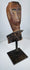 Weathered Southeast Asian ceremonial wood sculpture fragment with stylized protective figure appearance