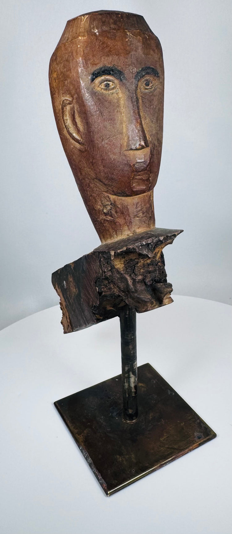Weathered Southeast Asian ceremonial wood sculpture fragment with stylized protective figure appearance