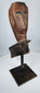 Weathered Southeast Asian ceremonial wood sculpture fragment with stylized protective figure appearance