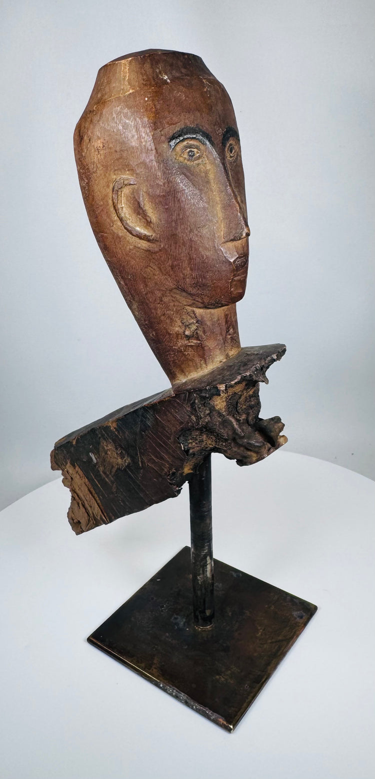 Antique carved wooden mythological figure fragment with natural weathering and age-related cracking