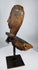 Hand-carved Southeast Asian hardwood spirit figure with weathered surface and geometric facial details