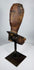 Carved hardwood ceremonial figure from Southeast Asia with elongated facial proportions