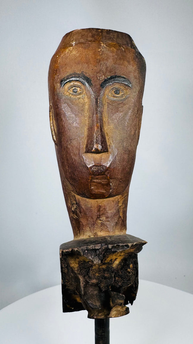 Southeast Asian tribal wooden ceremonial figure fragment mounted on a custom display stand