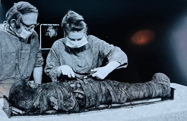Black-and-white photograph showing researchers studying Manchester Mummy 1770 during the 1975 scientific investigation.