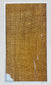 Close-up of the larger attributed mummy-wrapping fragment, showing woven linen texture, frayed edges and narrow separations.