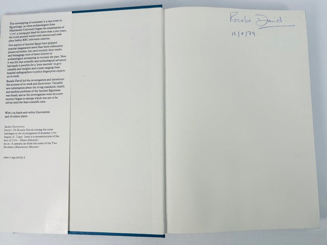 Open copy of Mysteries of the Mummies showing the dust-jacket flap and Rosalie David’s signed front endpaper.