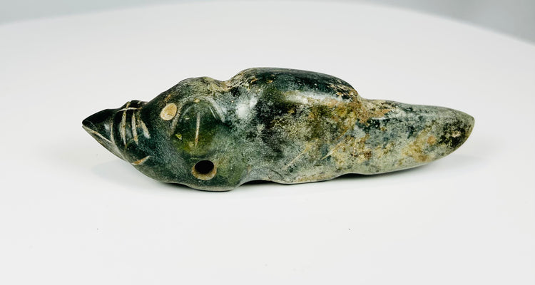 Pre-Columbian greenstone amulet depicting stylized animal figure with incised details