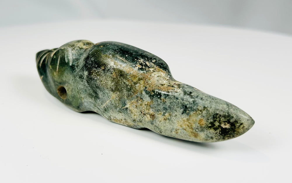Ancient carved greenstone effigy pendant with elongated tail and drilled eye details