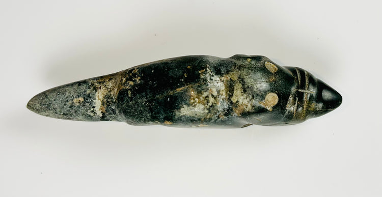 Ancient greenstone animal effigy with engraved facial features and smooth finish