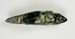 Ancient greenstone animal effigy with engraved facial features and smooth finish