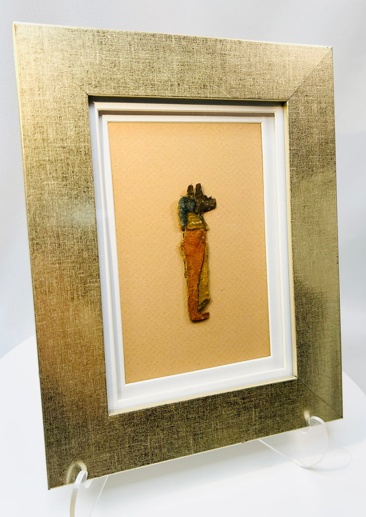 Egyptian cartonnage fragment depicting Anubis with jackal head and vivid colors