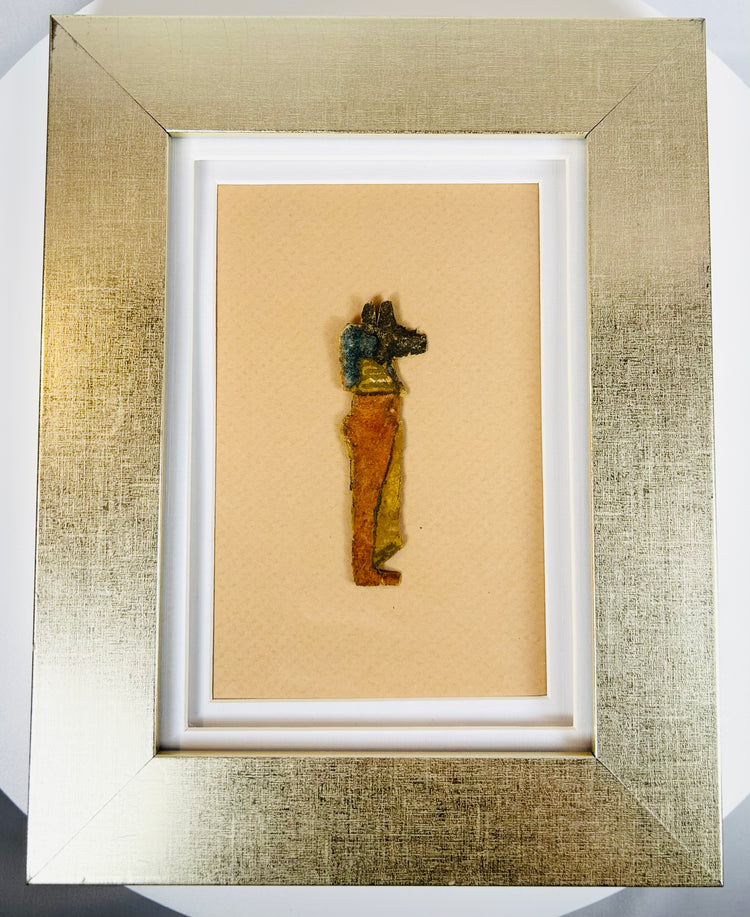 Ancient Egyptian Anubis fragment with red, yellow, and black painted decoration