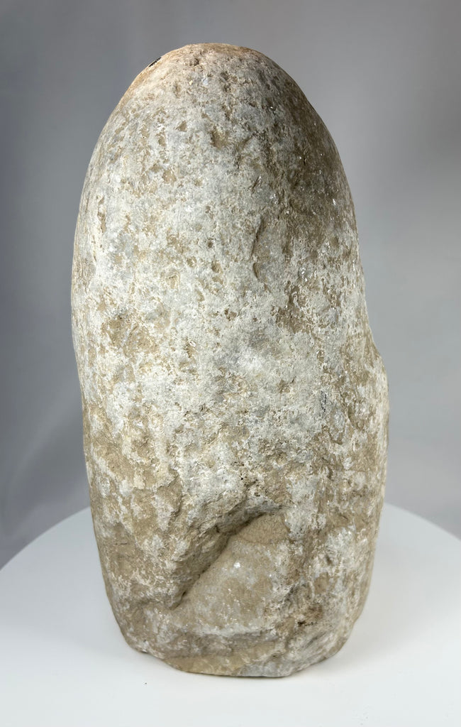 Early Near Eastern limestone idol with patinated surface and compact body
