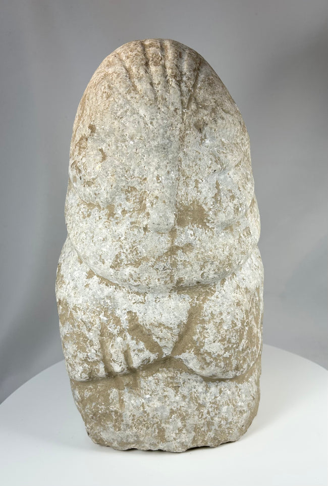 Limestone ritual figure from ancient Near East with heavy mineral deposits