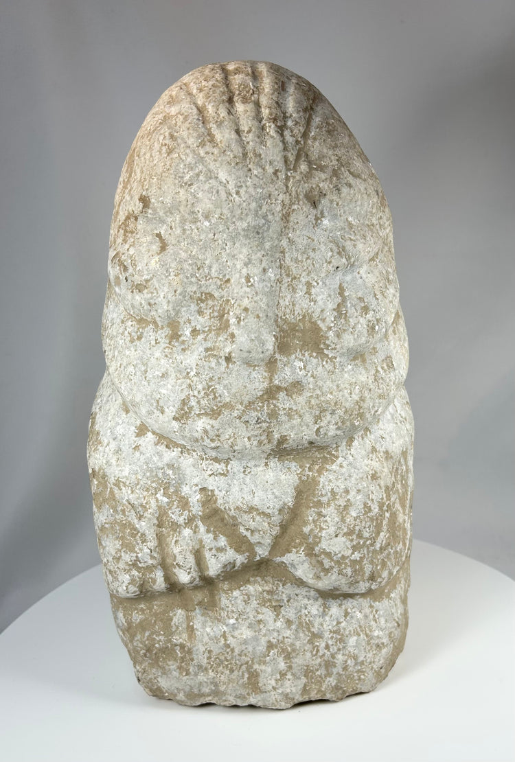 Limestone ritual figure from ancient Near East with heavy mineral deposits