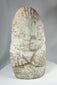 Limestone ritual figure from ancient Near East with heavy mineral deposits