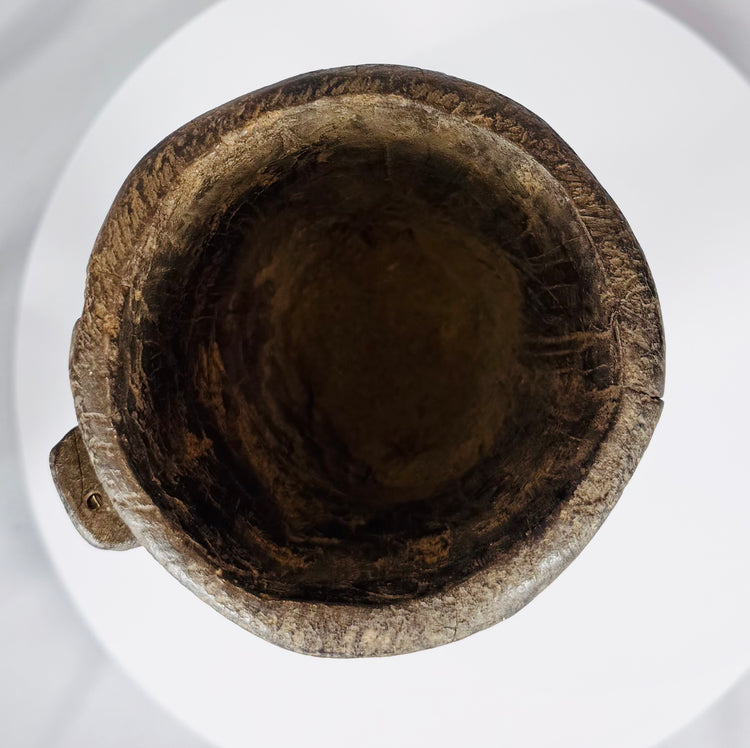 Antique Nepal or Tibet wooden domestic vessel displaying extensive age wear and natural wood texture