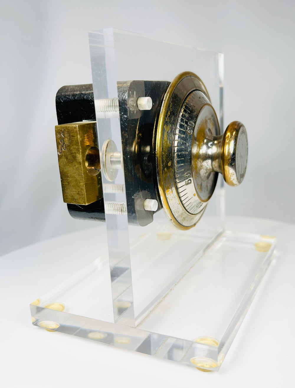 Antique safe lock display showing brass dial and exposed mechanical system