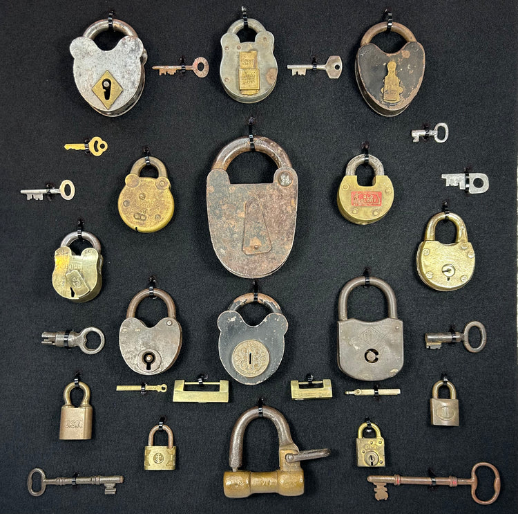 Framed industrial collection of antique locks with brass and iron examples