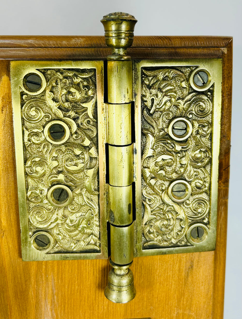 Victorian era brass door hardware with decorative escutcheon and hinge