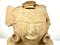 Pre-Columbian ceramic sculpture featuring a hollow opening at the rear, traditional hand-modeled construction, and natural mineral deposits.
