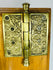Victorian era brass door hardware with decorative escutcheon and hinge