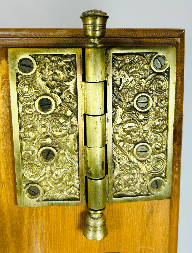 Victorian era brass door hardware with decorative escutcheon and hinge