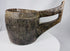 Hand-carved wooden vessel from Nepal or Tibet featuring a deep basin and curved handle