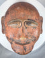 African ethnographic ceremonial mask with weathered surface, carved details, and ritual character