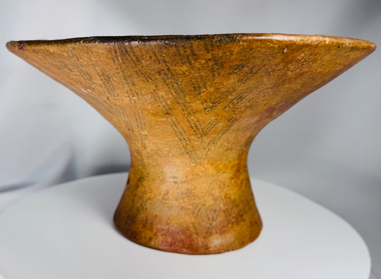 Ancient ceremonial earthenware bowl with geometric decoration and natural mineral deposits