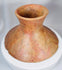 Handcrafted ancient American terracotta vessel with elevated base and ritual ceremonial character