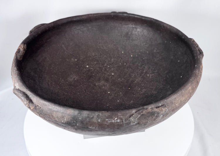 Pre-Columbian earthenware vessel featuring a hemispherical form and fire-clouded patina