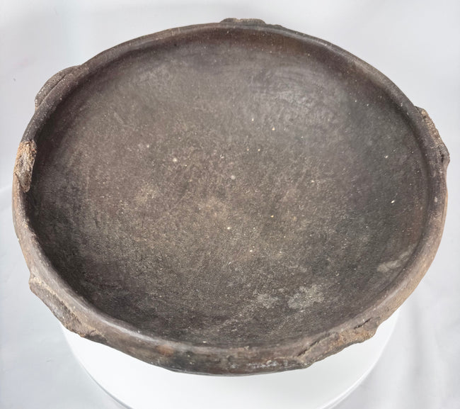 Pre-Columbian terracotta bowl featuring hand-finished irregularities and raised rim elements