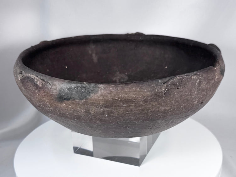 Pre-Columbian ceramic bowl with dark firing coloration and sculptural rounded profile