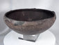 Pre-Columbian ceramic bowl with dark firing coloration and sculptural rounded profile