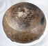 Ancient earthenware bowl with hemispherical body, fire-clouded finish, and aged patina