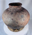 Antique Timor storage vessel featuring hand-painted scroll motifs and warm earthen patina