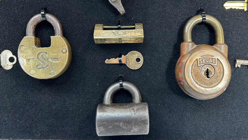 Industrial era lock and key collection arranged in symmetrical shadow box presentation