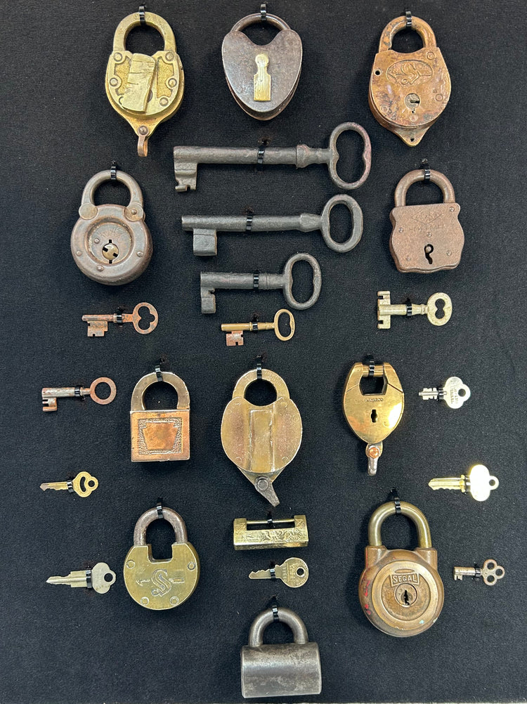 Antique security hardware collection with brass and iron padlocks and matching keys