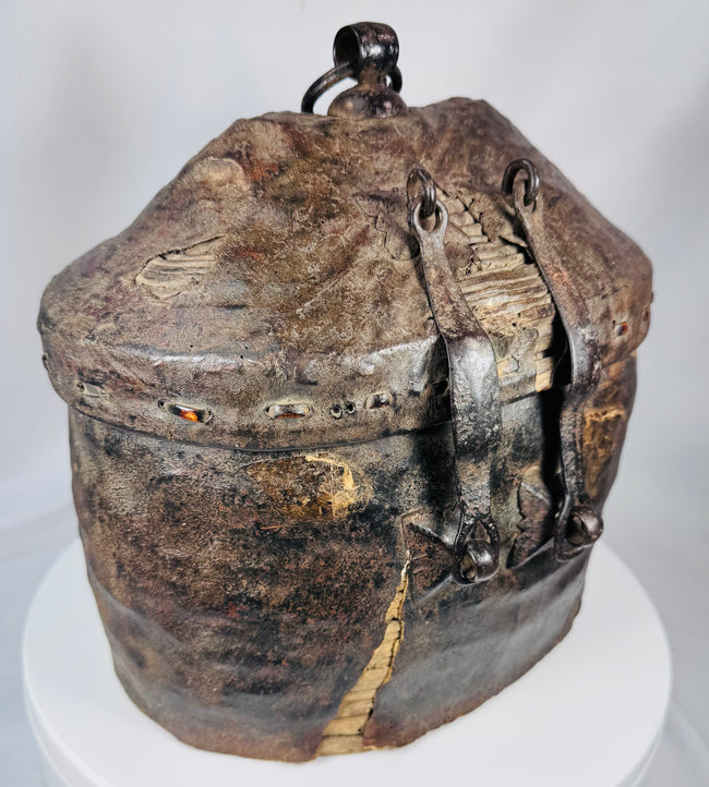 Traditional Tibetan travel basket constructed from woven reed, hide, and iron fittings