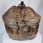 Himalayan provisions container featuring coiled basketry construction and leather exterior